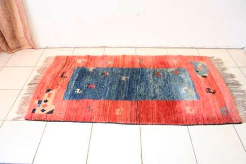 A fabulous thick pile colourful carpet in shades of red and blue colours.