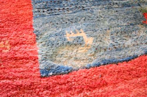 A fabulous thick pile colourful carpet in shades of red and blue colours.