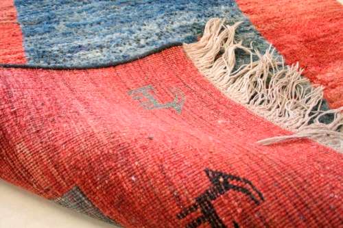 A fabulous thick pile colourful carpet in shades of red and blue colours.