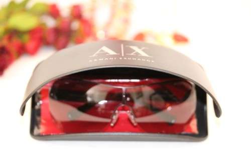 **rs17** A pair of black Armani Exchange (model AX2007) unisex sunglasses in its original case