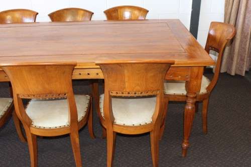 A magnificent Balinese Teak 8-seater dining suite with stylish upholstered curved-back chairs