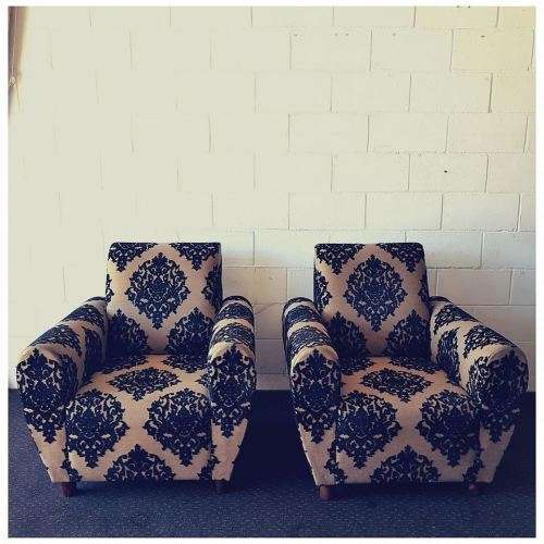 A one seater sofa chair upholstered in a stunning brocade fabric with wooden legs