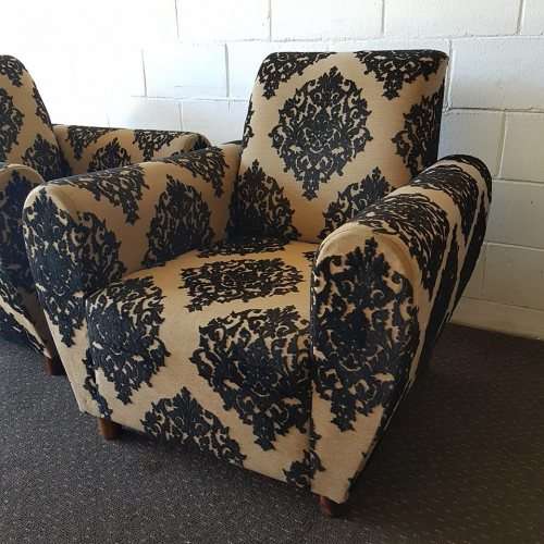 A one seater sofa chair upholstered in a stunning brocade fabric with wooden legs