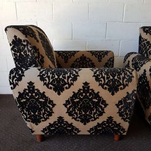 A one seater sofa chair upholstered in a stunning brocade fabric with wooden legs