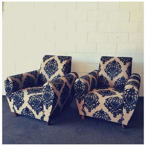 A one seater sofa chair upholstered in a stunning brocade fabric with wooden legs