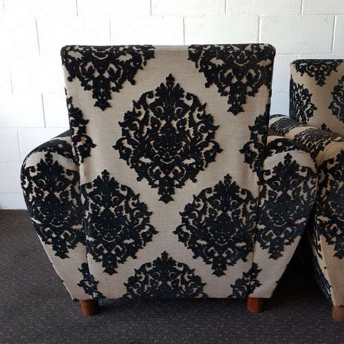A one seater sofa chair upholstered in a stunning brocade fabric with wooden legs