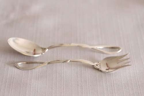 A beautiful antique sterling silver Art Nouveau (c1895 to 1910) USA made fruit spoon & fork set