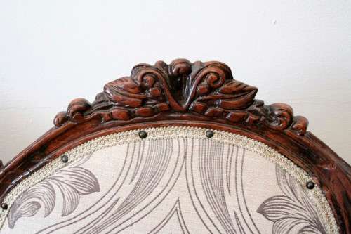 An exquisite antique Victorian carved settee with stylish new upholstery.