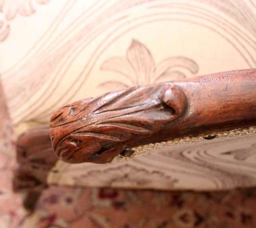 An exquisite antique Victorian carved settee with stylish new upholstery.
