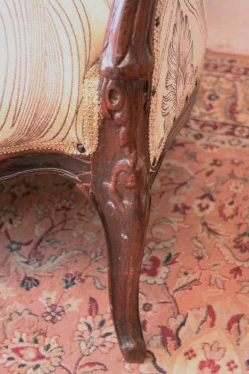 An exquisite antique Victorian carved settee with stylish new upholstery.
