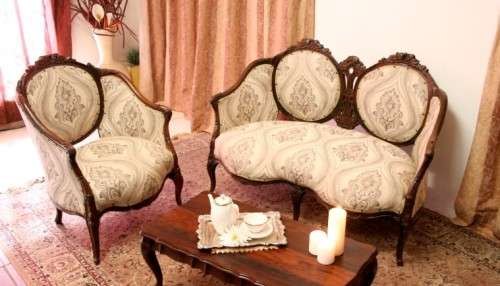 An elegant hand carved Victorian arm chair with gorgeous new fabric.