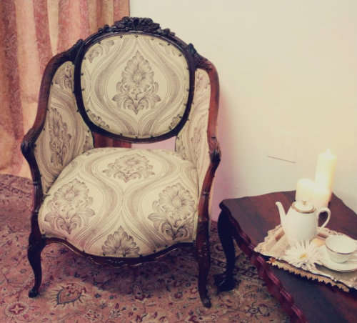 An elegant hand carved Victorian arm chair with gorgeous new fabric.