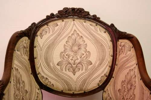 An elegant hand carved Victorian arm chair with gorgeous new fabric.
