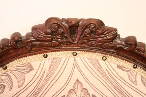 An elegant hand carved Victorian arm chair with gorgeous new fabric.