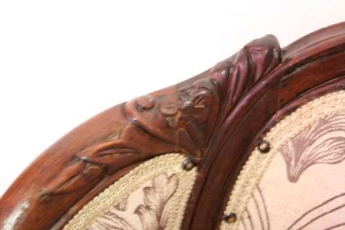 An elegant hand carved Victorian arm chair with gorgeous new fabric.