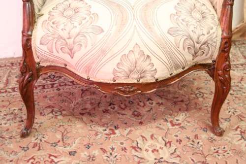 An elegant hand carved Victorian arm chair with gorgeous new fabric.