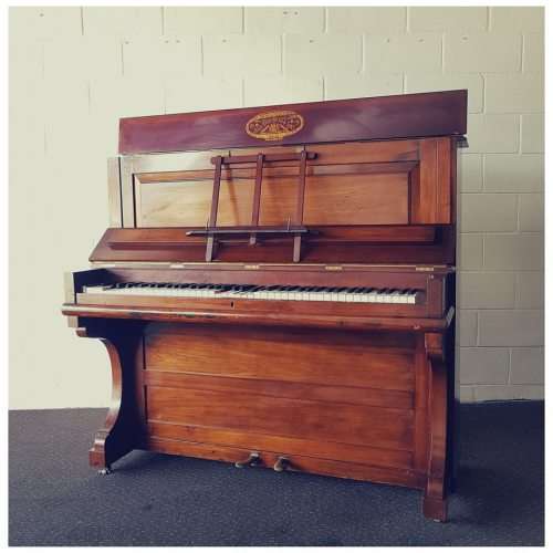 A spectacular antique Edwardian "John Brinsmead & Sons" upright piano - elegant addition to a lounge
