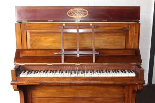 A spectacular antique Edwardian "John Brinsmead & Sons" upright piano - elegant addition to a lounge