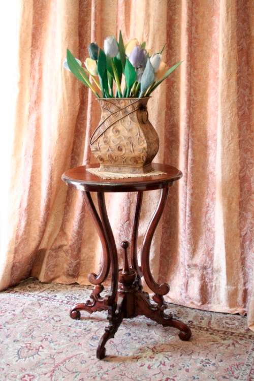 A fabulous stylish vintage Teak display/ occasional table with a ornate centre leg