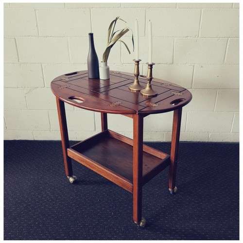 A superb Mahogany and Teak tea trolley with removable butlers tray, brass hinges on original castors