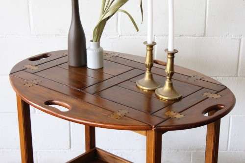 A superb Mahogany and Teak tea trolley with removable butlers tray, brass hinges on original castors