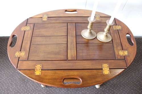 A superb Mahogany and Teak tea trolley with removable butlers tray, brass hinges on original castors