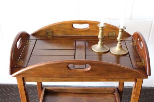 A superb Mahogany and Teak tea trolley with removable butlers tray, brass hinges on original castors