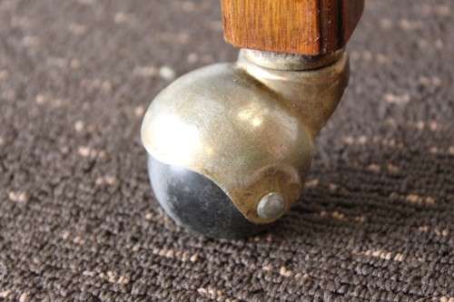A superb Mahogany and Teak tea trolley with removable butlers tray, brass hinges on original castors