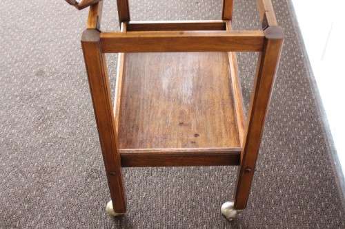 A superb Mahogany and Teak tea trolley with removable butlers tray, brass hinges on original castors