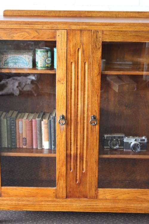 A wonderful Art Deco vintage oak display/ show cabinet with glass doors and carved detailing!