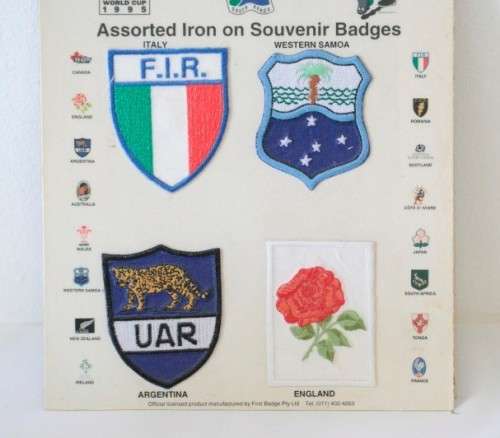 An awesome "1995 Rugby World Cup" commemorative jug and 16 iron on badges on display cards