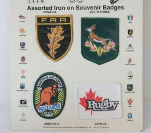 An awesome "1995 Rugby World Cup" commemorative jug and 16 iron on badges on display cards