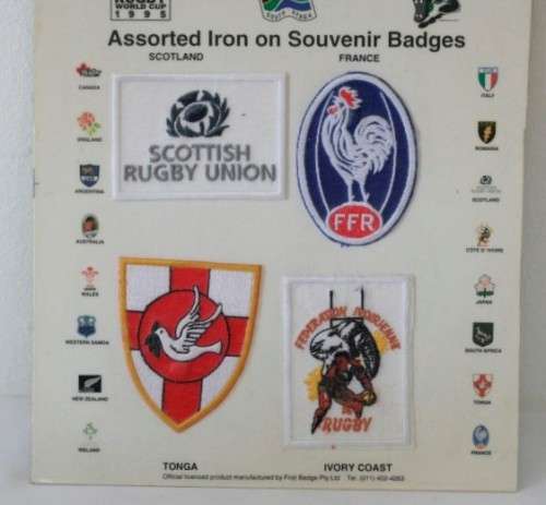 An awesome "1995 Rugby World Cup" commemorative jug and 16 iron on badges on display cards
