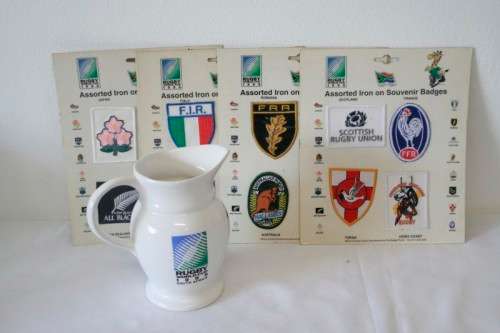 An awesome "1995 Rugby World Cup" commemorative jug and 16 iron on badges on display cards