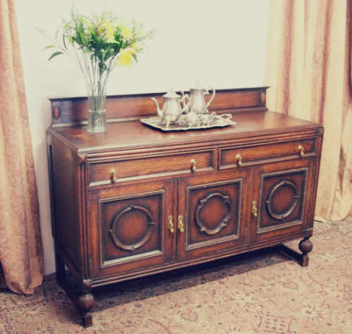An exquisite vintage Oak side server cabinet with brass handles & loads of drawer & cupboard space