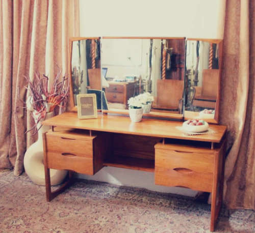 An exquisite Teak retro styled four drawer side-folding mirror dressing table and stool.