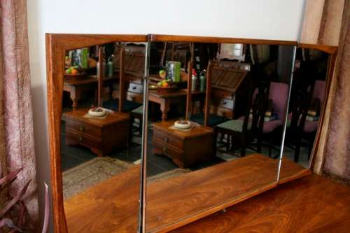 An exquisite Teak retro styled four drawer side-folding mirror dressing table and stool.