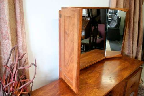An exquisite Teak retro styled four drawer side-folding mirror dressing table and stool.