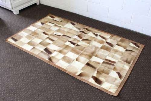 **RS17** A stunning rectangular (1,8m x 1,07m) Springbok hide rug/ mat with hand stitched detailing