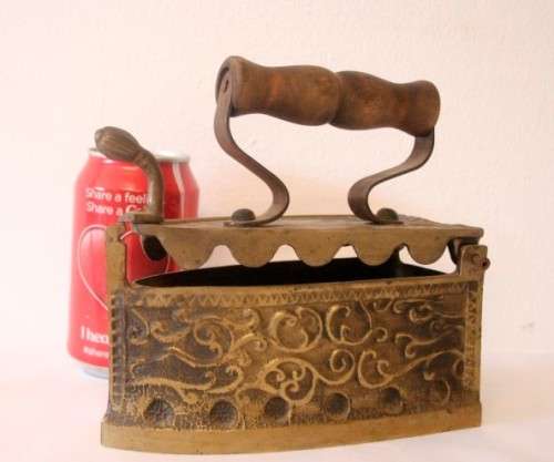A fabulous very ornate antique brass sad iron/coal iron. Stunning as a display piece.