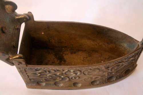 A fabulous very ornate antique brass sad iron/coal iron. Stunning as a display piece.