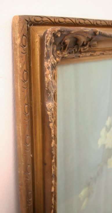 A fabulous antique moulded picture frame with a gorgeous flower print behind glass..