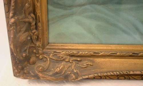 A fabulous antique moulded picture frame with a gorgeous flower print behind glass..