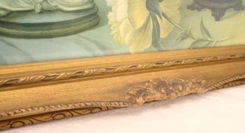 A fabulous antique moulded picture frame with a gorgeous flower print behind glass..