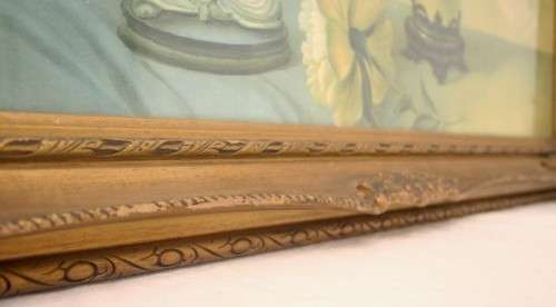 A fabulous antique moulded picture frame with a gorgeous flower print behind glass..