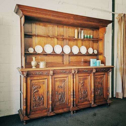 An impressive antique 19th-century Flemish honeyed Oak double-buffet w/ incredible carved detailing