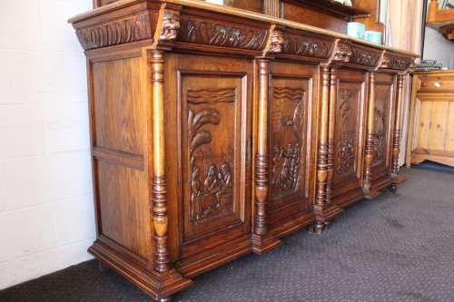 An impressive antique 19th-century Flemish honeyed Oak double-buffet w/ incredible carved detailing