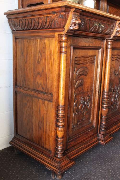 An impressive antique 19th-century Flemish honeyed Oak double-buffet w/ incredible carved detailing