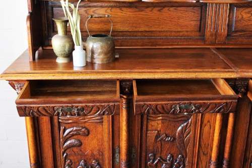 An impressive antique 19th-century Flemish honeyed Oak double-buffet w/ incredible carved detailing