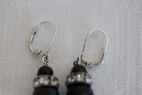 A gorgeous matching black stone and silver metal pendant and earring set with diamante